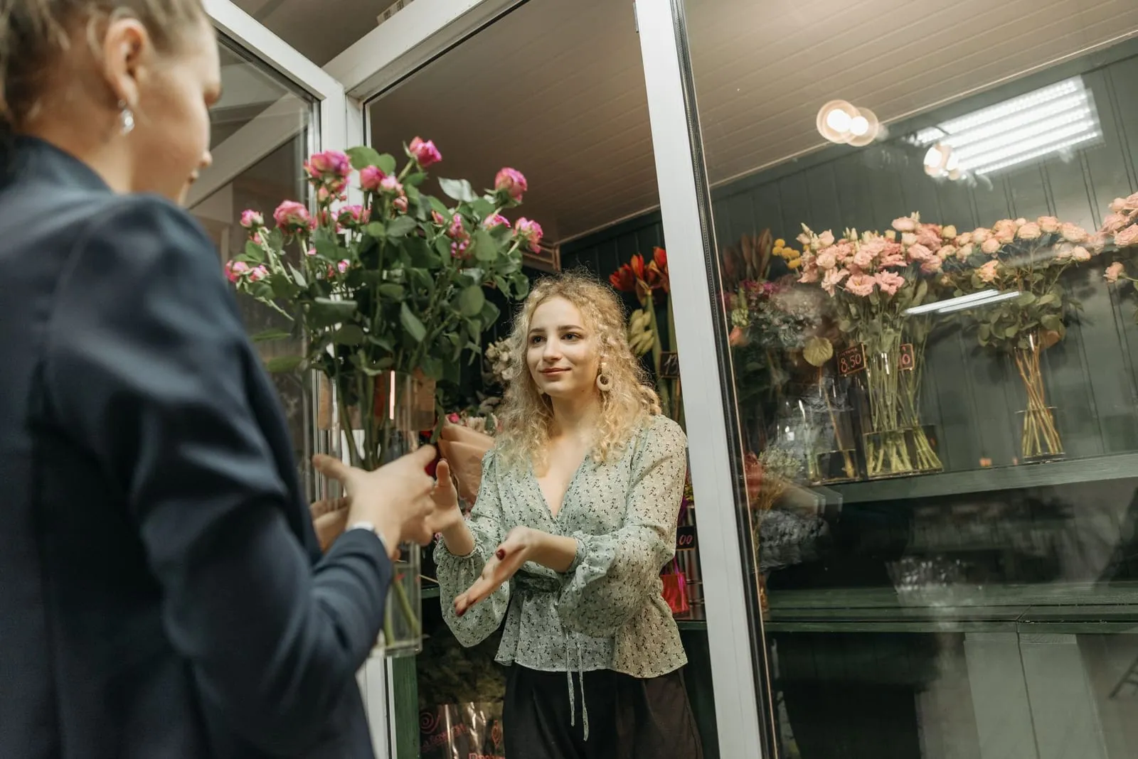 A florist serving a customer inside the Bloom & Stem flower shop on Great Minster Street