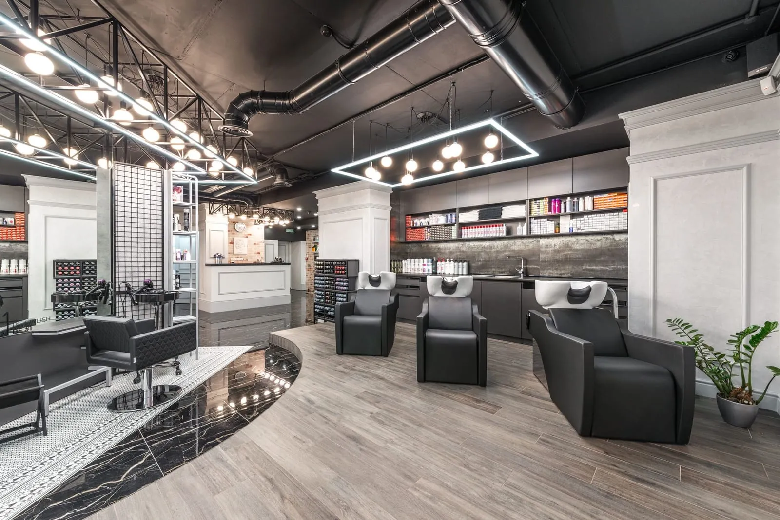 Interior of Lumière Hair & Beauty — a modern, upscale salon with styling chairs and warm lighting