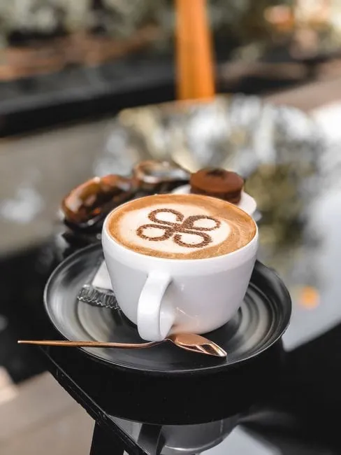 A flat white with delicate latte art in a ceramic cup